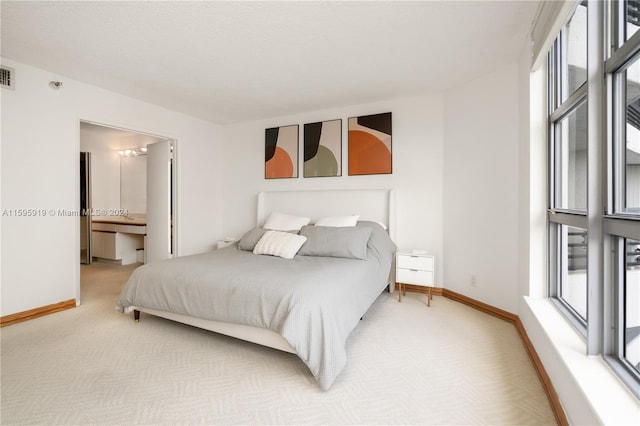 bedroom featuring carpet flooring and connected bathroom