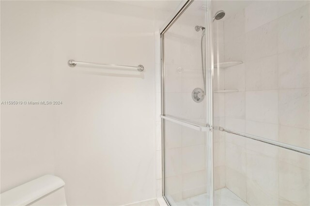 bathroom with walk in shower and toilet