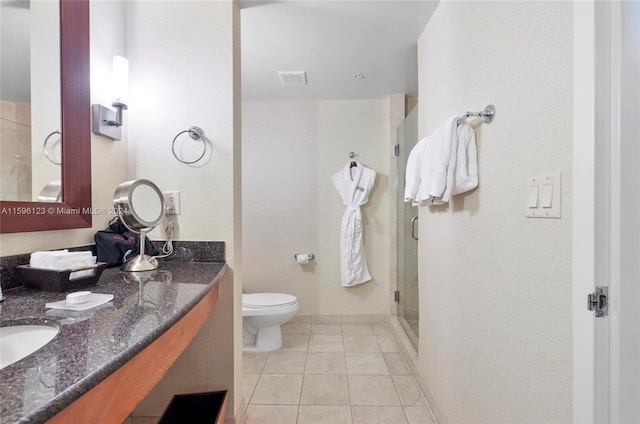 bathroom featuring dual sinks, tile flooring, an enclosed shower, toilet, and large vanity