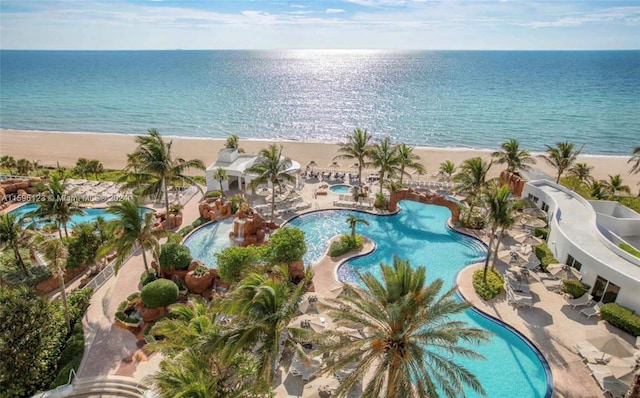 birds eye view of property with a beach view and a water view