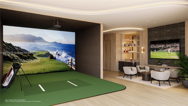 rec room featuring wood-type flooring, golf simulator, and a mountain view