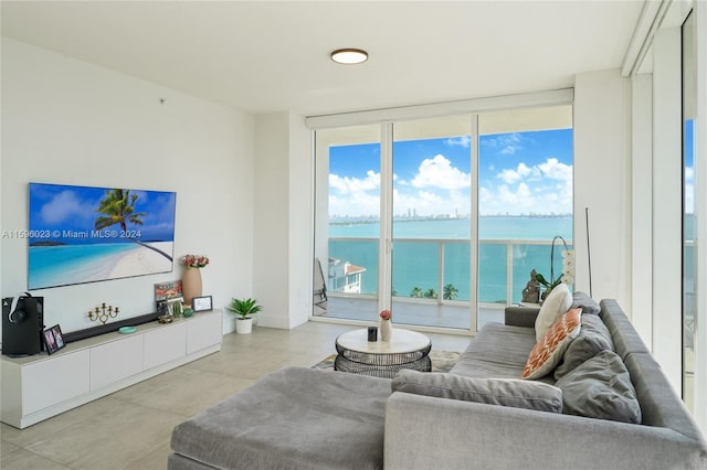 living room with expansive windows and a water view