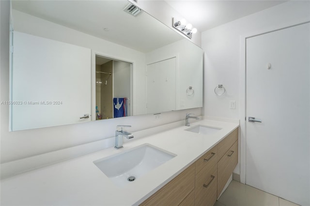 bathroom featuring tile patterned flooring and vanity