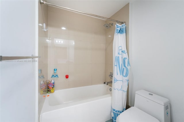 bathroom featuring shower / bath combo and toilet