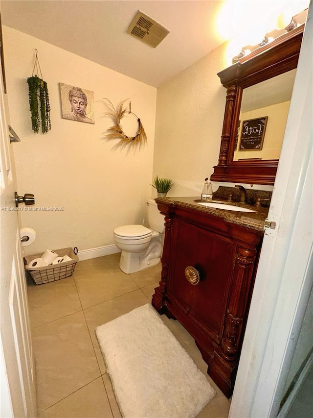 bathroom with visible vents, baseboards, toilet, tile patterned floors, and vanity