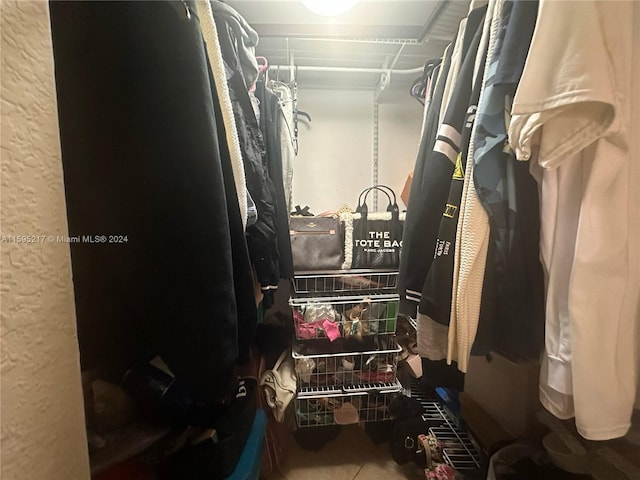 spacious closet featuring tile patterned floors