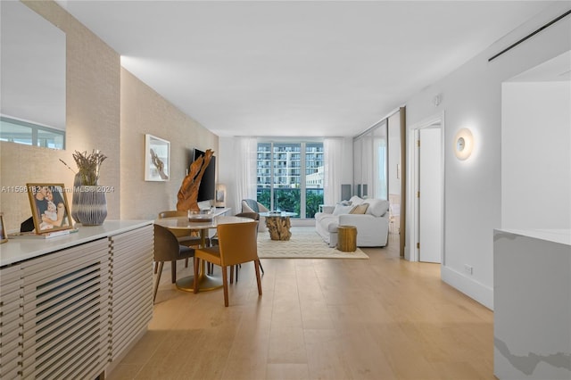 interior space with floor to ceiling windows and light wood finished floors