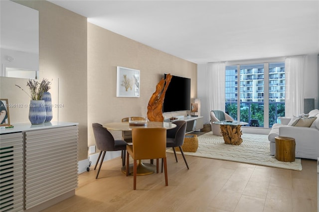 dining area featuring light wood-style floors