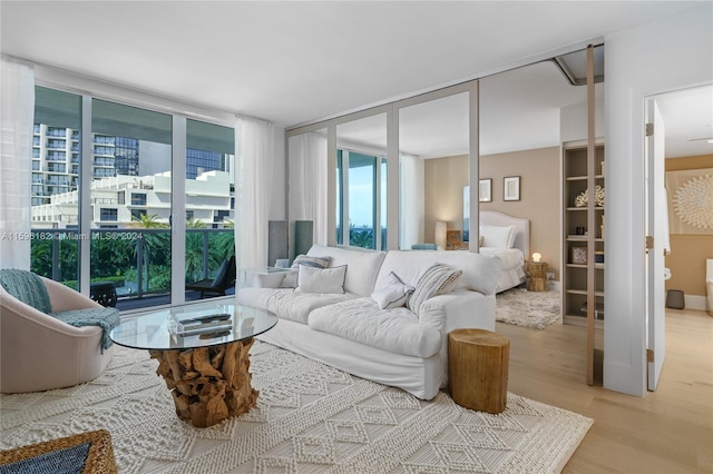 living room featuring light wood-style flooring and expansive windows