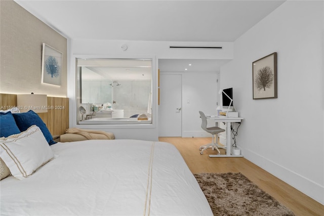 bedroom featuring baseboards and wood finished floors