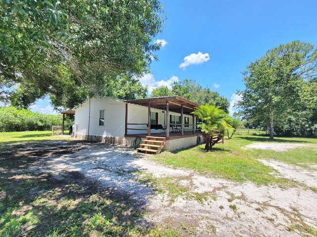 view of front of property featuring covered porch and a front yard