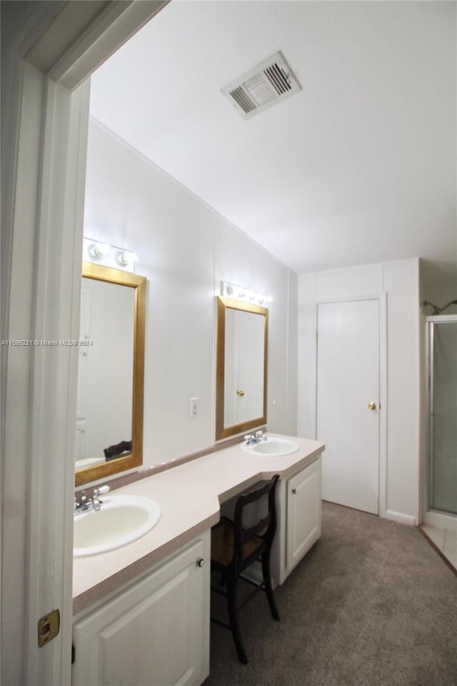 bathroom featuring walk in shower, lofted ceiling, and vanity