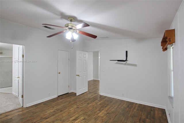 empty room with dark wood-type flooring and ceiling fan