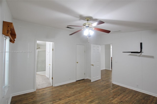 unfurnished bedroom with dark hardwood / wood-style floors, ceiling fan, and ensuite bathroom