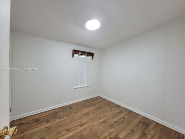 spare room with dark wood-type flooring