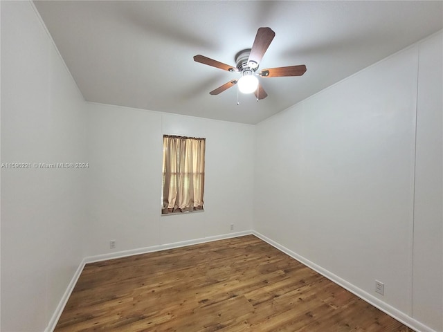 spare room with hardwood / wood-style floors and ceiling fan