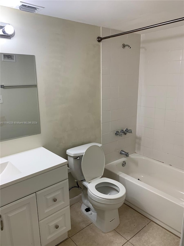 full bathroom with toilet, tile patterned flooring, vanity, and tiled shower / bath