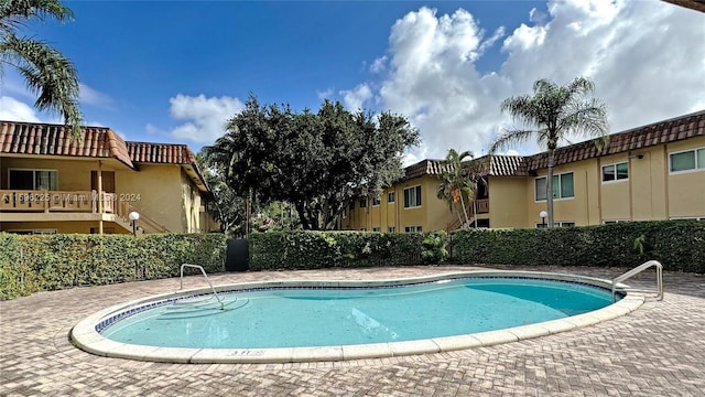 view of swimming pool featuring a patio area