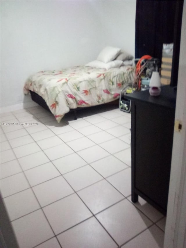 bedroom featuring light tile floors