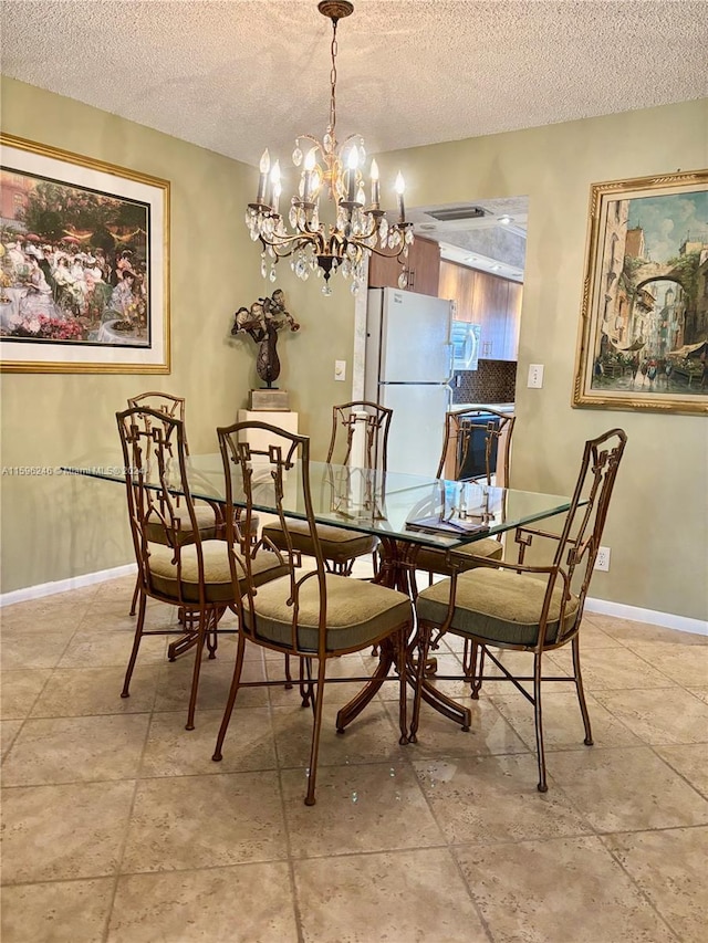 dining room with a textured ceiling and a chandelier