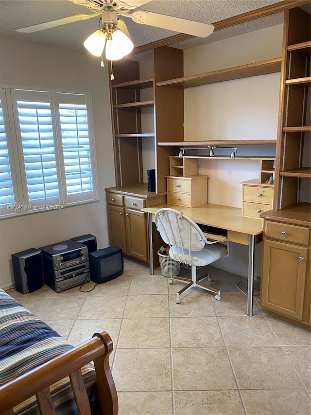 home office with ceiling fan and a textured ceiling