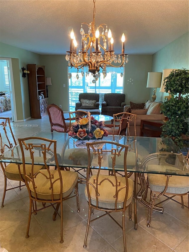 dining room featuring a textured ceiling and a chandelier