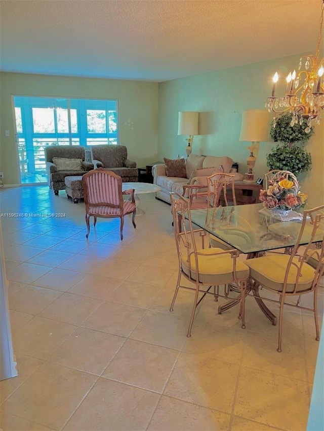 dining space featuring a notable chandelier, light tile patterned floors, and a textured ceiling