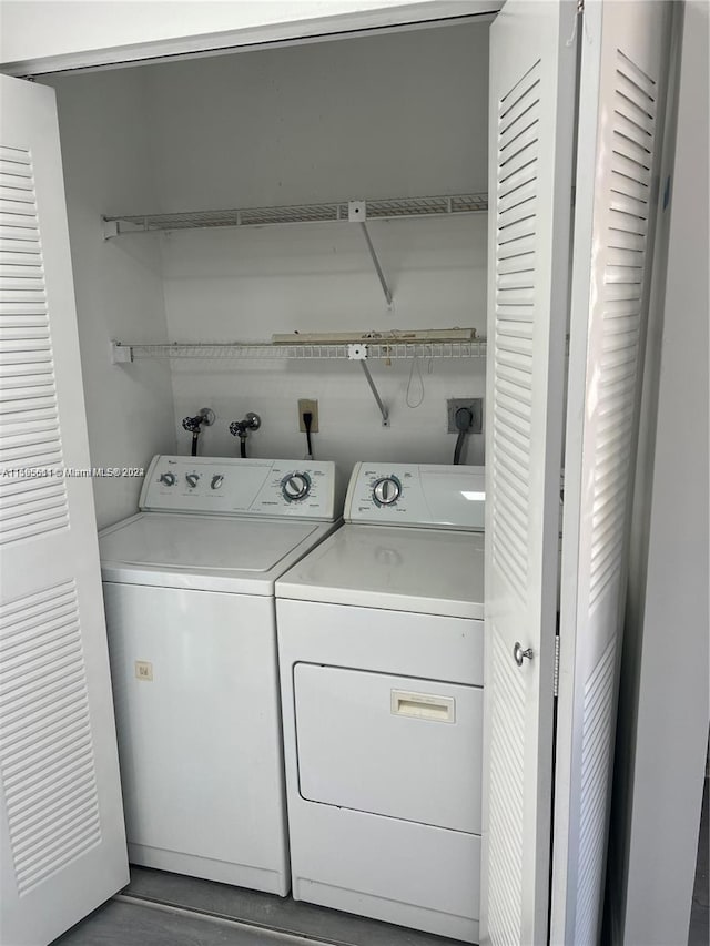 laundry room with washing machine and clothes dryer