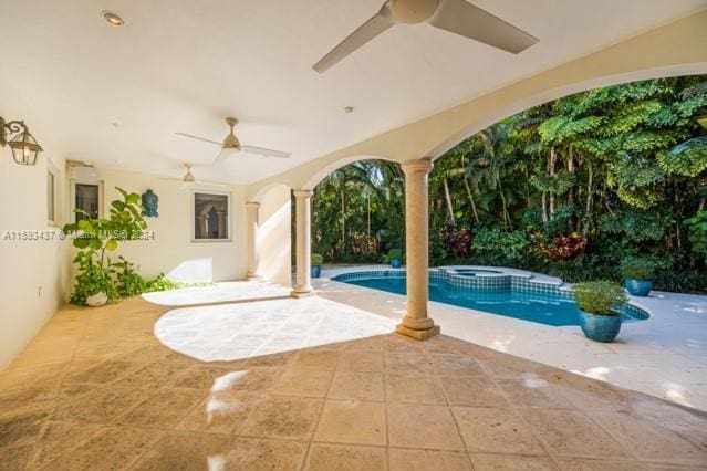 view of pool featuring a patio area and an in ground hot tub