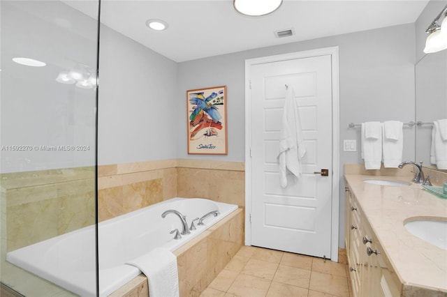 bathroom with vanity and a relaxing tiled tub