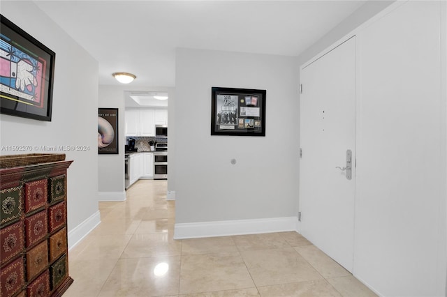 hallway with light tile patterned floors