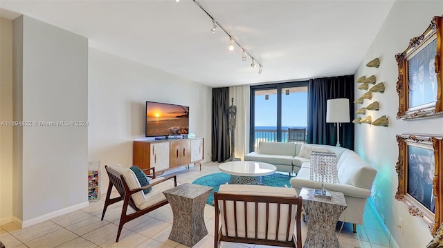 living room featuring expansive windows and light tile patterned floors