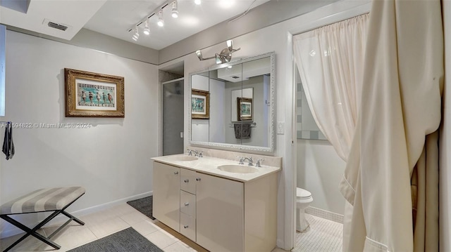 bathroom with walk in shower, vanity, tile patterned floors, and toilet