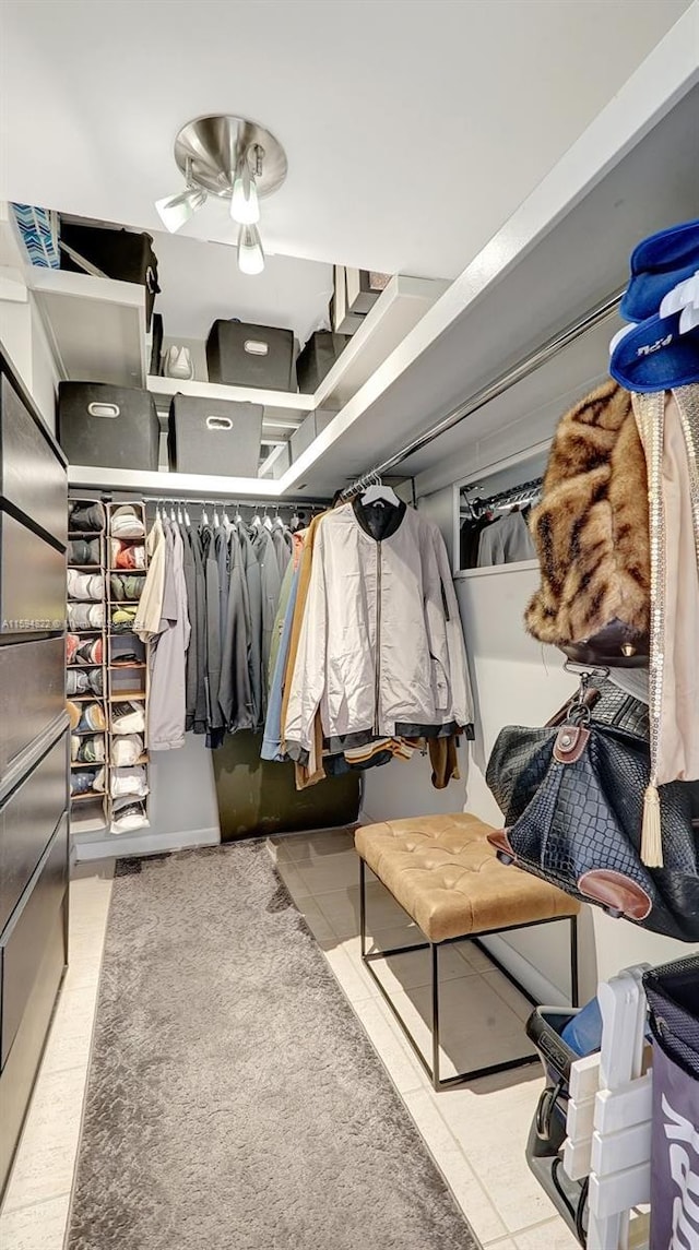 spacious closet featuring ceiling fan and light tile patterned floors