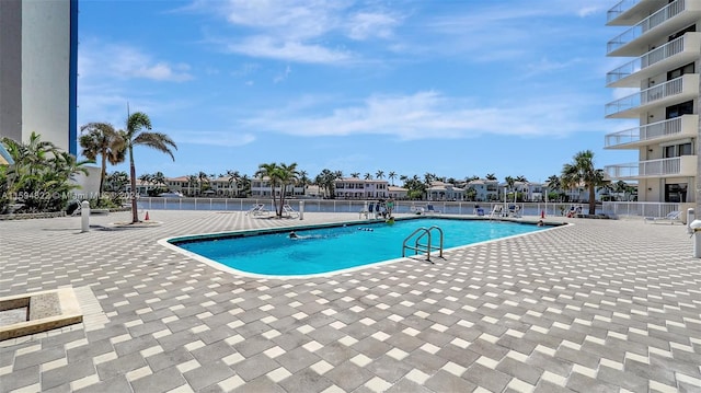 view of swimming pool with a patio area