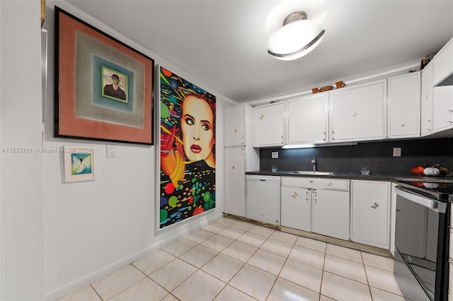 kitchen featuring electric stove, white cabinets, backsplash, and light tile floors