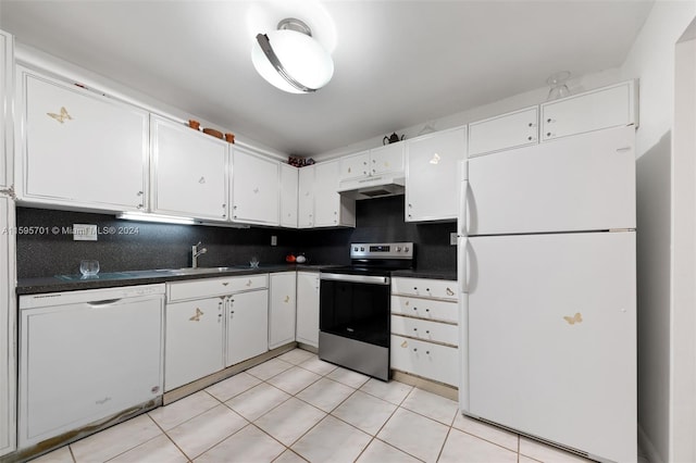 kitchen featuring sink, light tile floors, white appliances, and backsplash