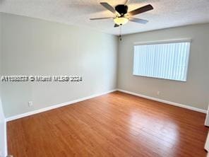 empty room featuring ceiling fan and wood-type flooring