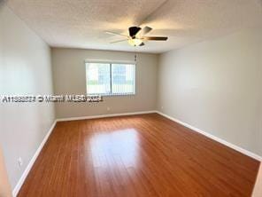 unfurnished room featuring ceiling fan and hardwood / wood-style floors