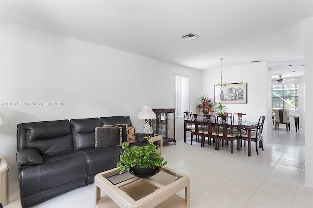 living room featuring an inviting chandelier and light tile patterned floors