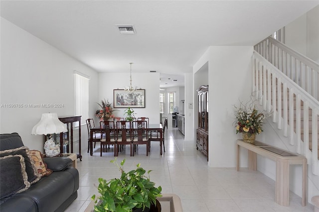 living room featuring a chandelier and light tile patterned floors