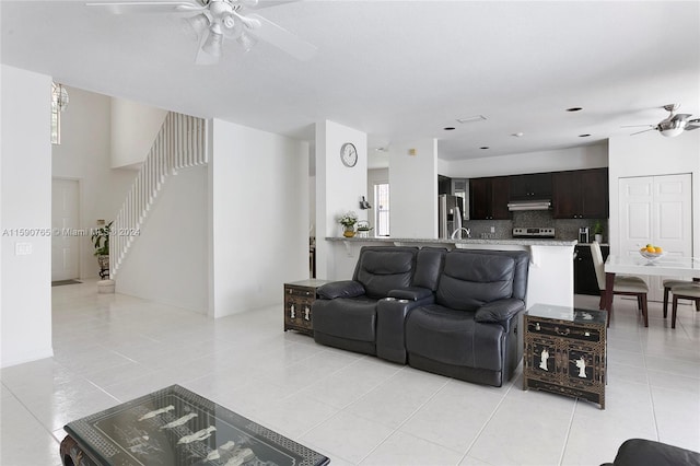 tiled living room with ceiling fan