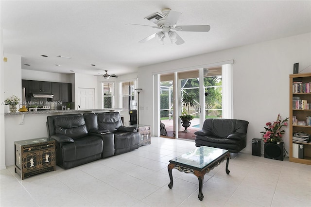 tiled living room featuring ceiling fan