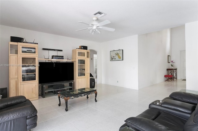 tiled living room with ceiling fan