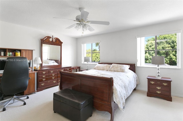 bedroom with light carpet, a textured ceiling, and ceiling fan