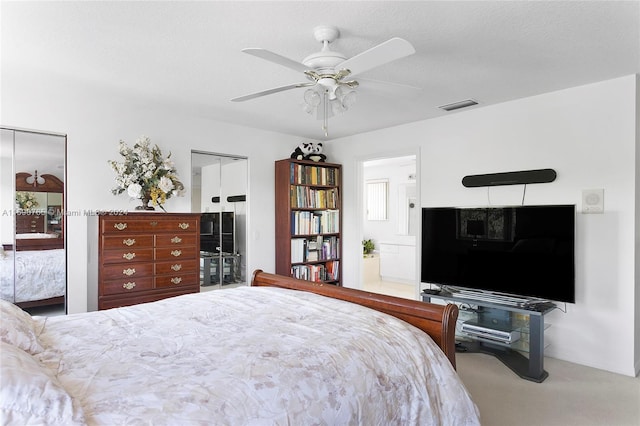 carpeted bedroom featuring ceiling fan and a textured ceiling