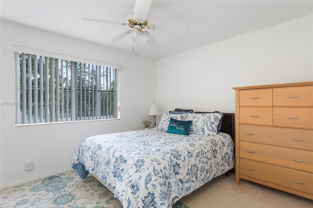 bedroom with light colored carpet and ceiling fan