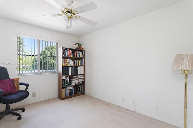 carpeted home office with ceiling fan