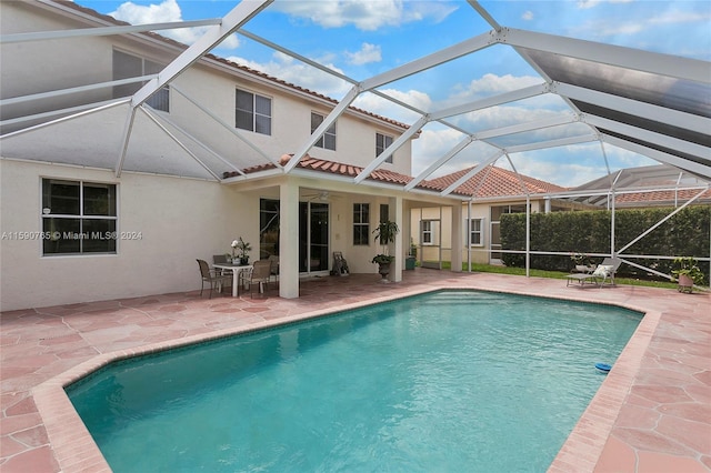 view of pool with a lanai and a patio