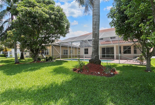 back of house with a patio, a lanai, and a lawn